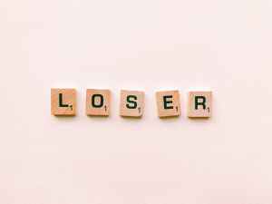 closeup photography of loser scrabble letter